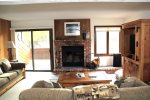 Mammoth Lakes Rental Sunrise 32 - Living Room with Woodstove and Access to Outdoor Deck
